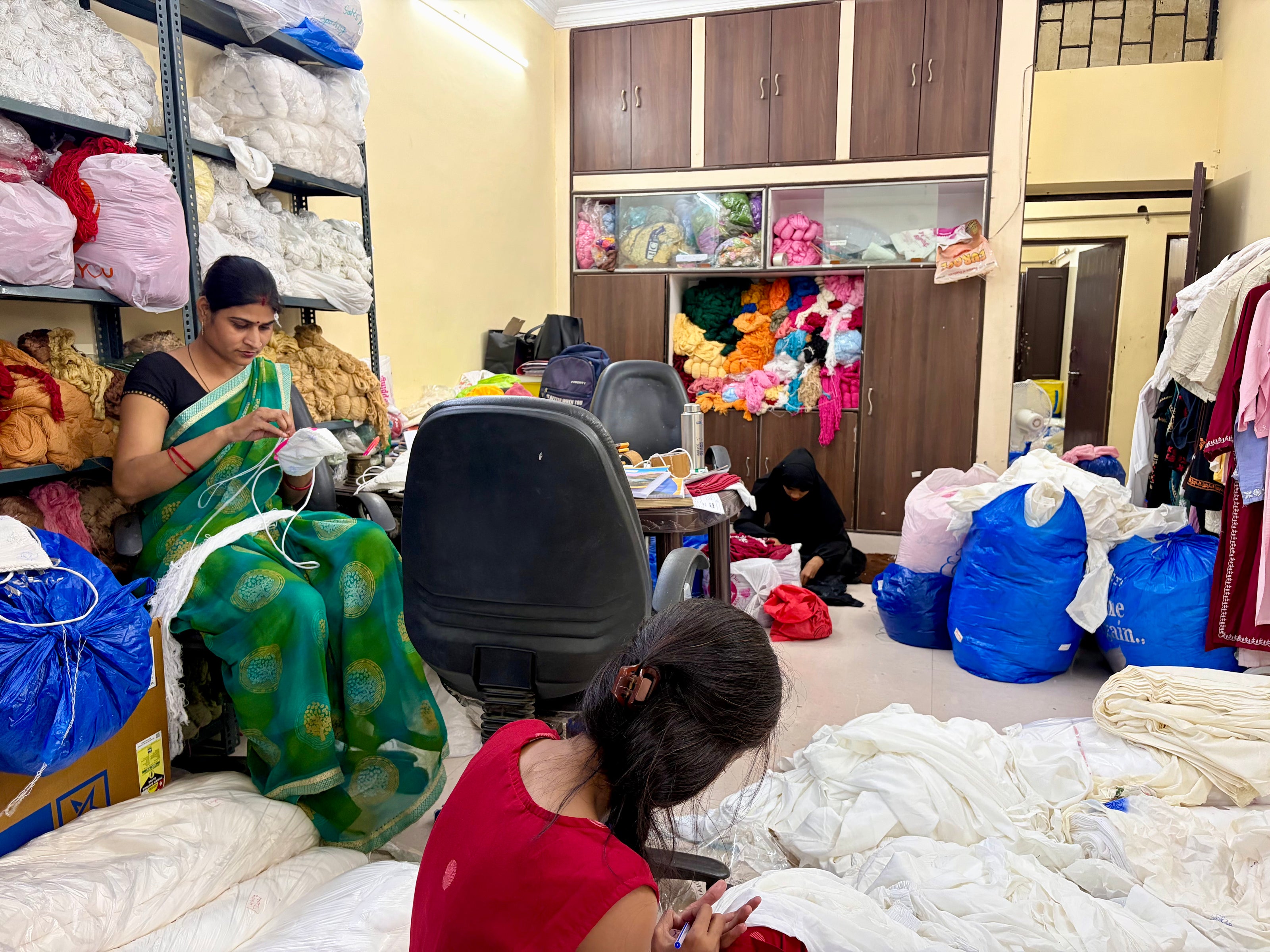 Chikankari handwork artisans working on fabric 