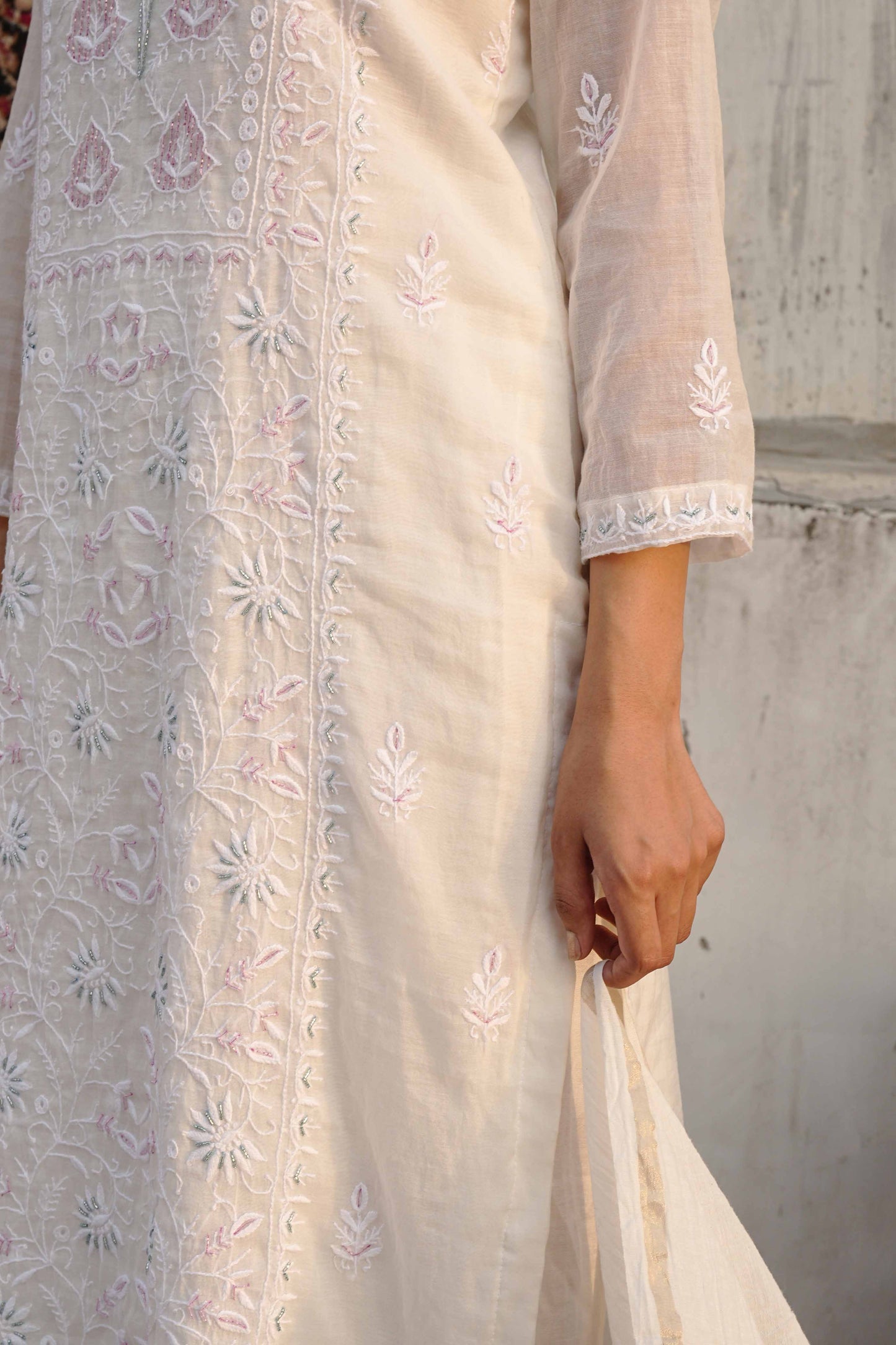 Sophisticated white Mul Chanderi suit detailed with traditional Lucknowi chikankari patterns.
High-quality ethnic evening wear from Art of Awadh, ideal for your next special occasion.
