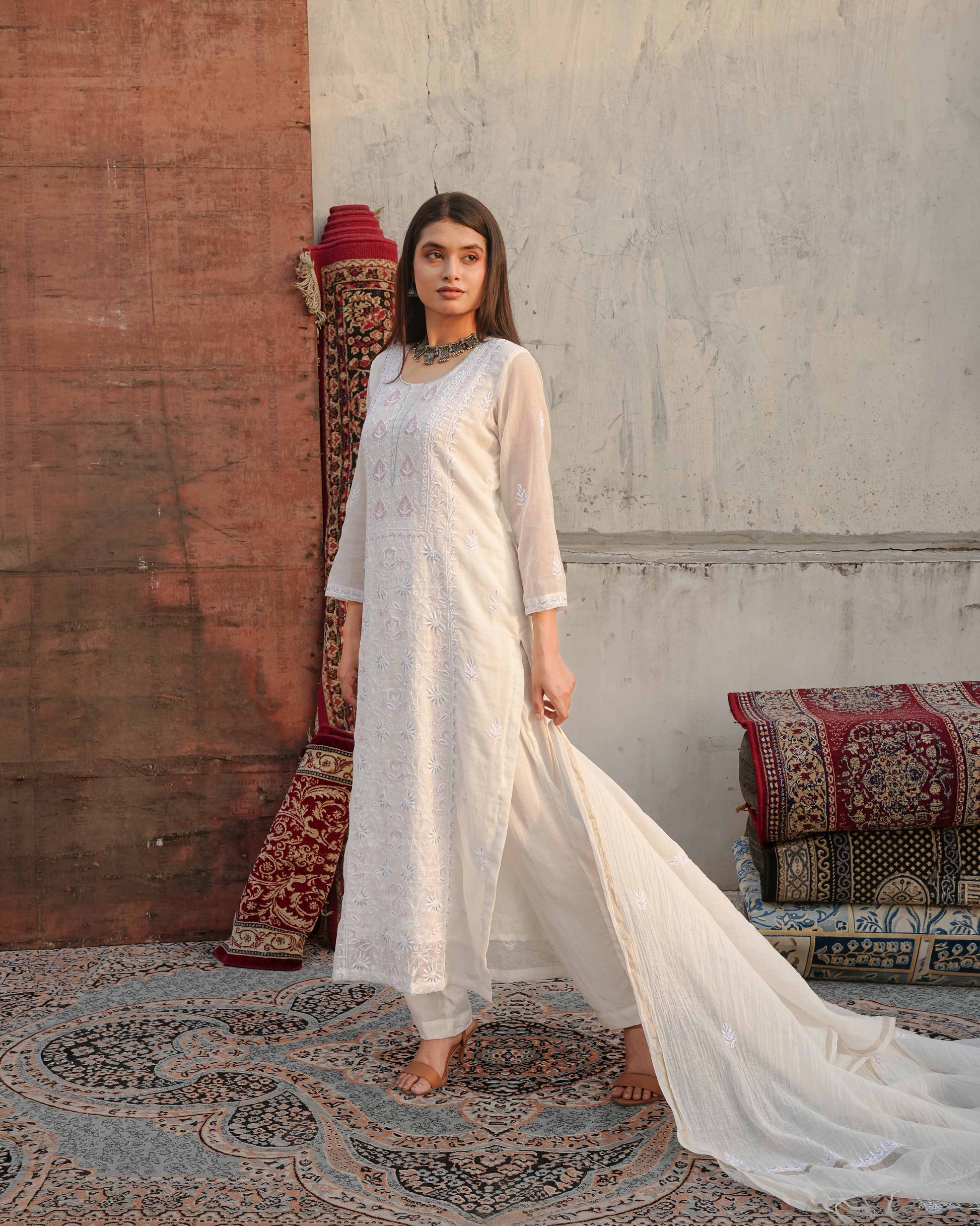 Luxurious white Mul Chanderi suit featuring intricate Lucknowi chikankari embroidery.
The perfect graceful ensemble for evening parties and sophisticated traditional events.
