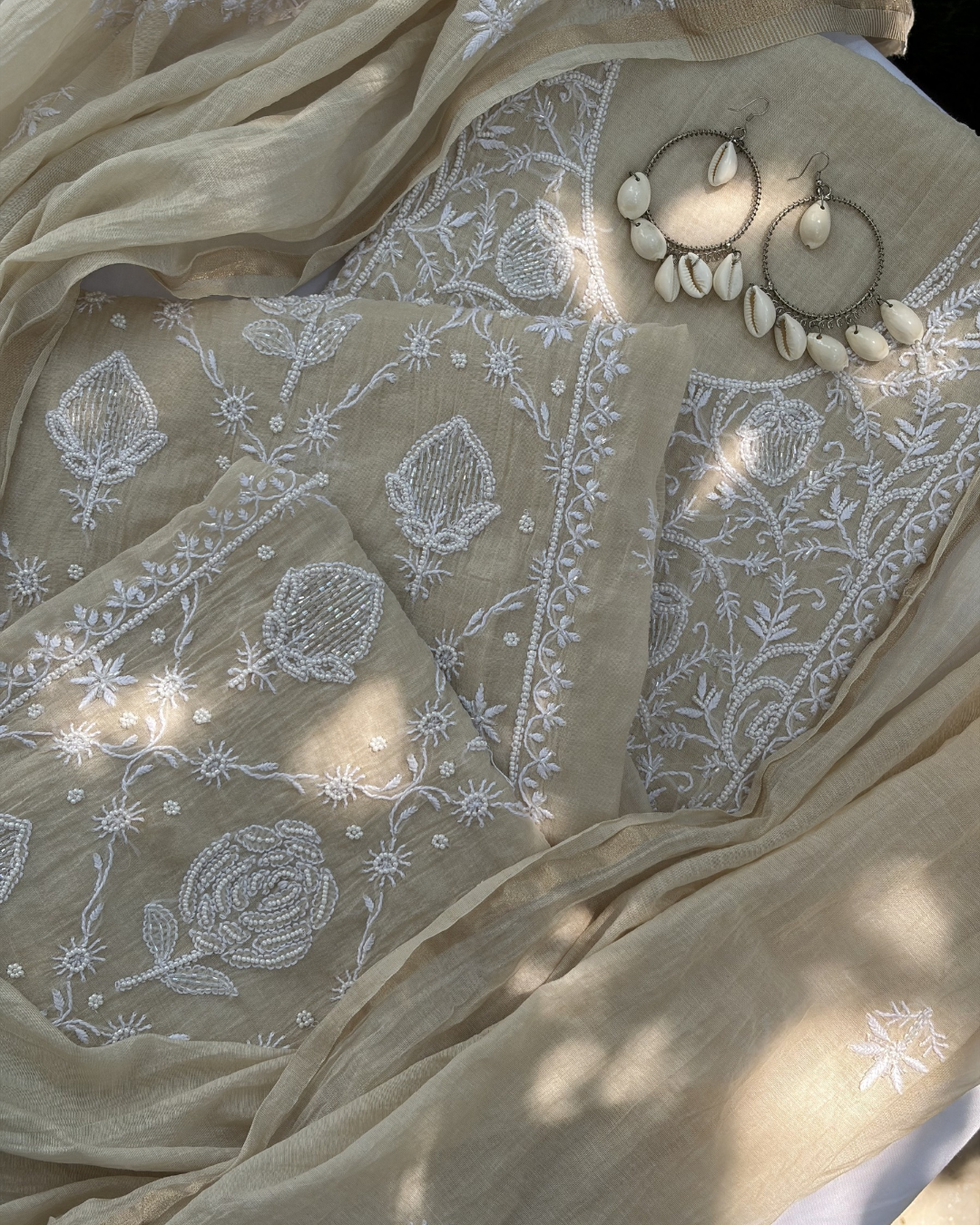 Elegant beige mul chanderi ensemble showcasing Lucknowi chikankari art of awadh for celebrations.