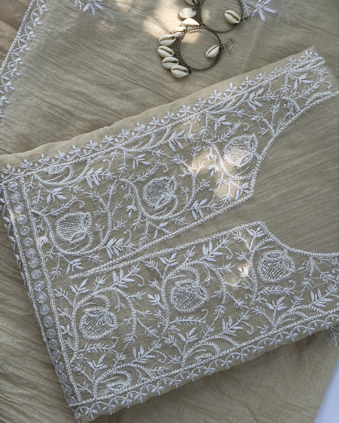 Traditional Lucknowi chikankari art of awadh on beige mul chanderi fabric for daytime events.