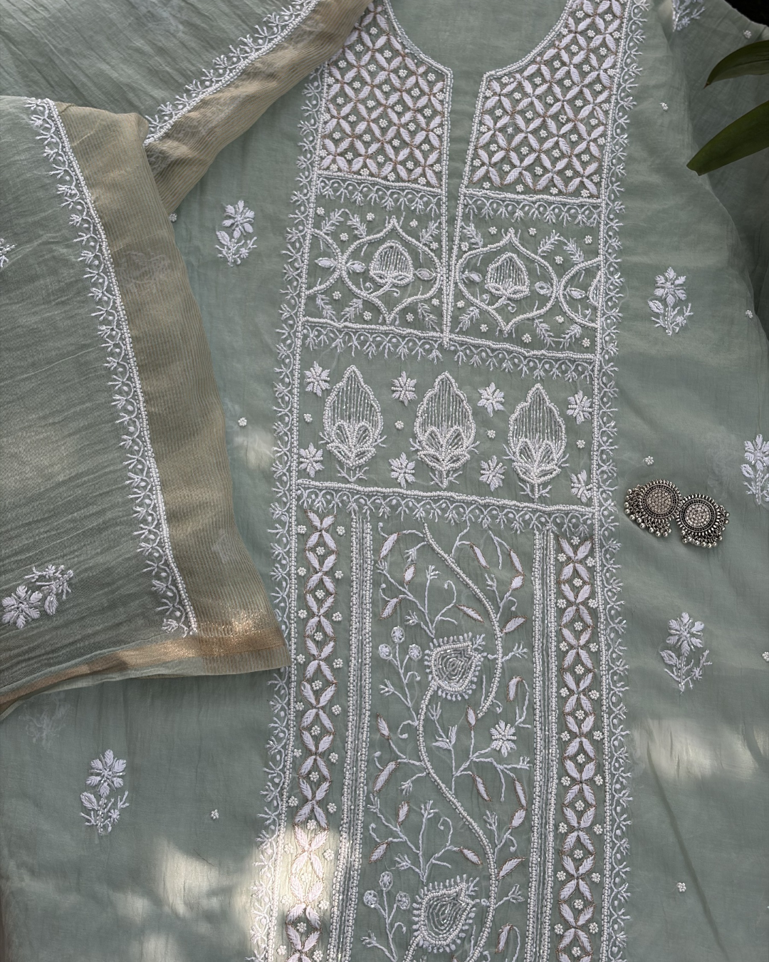Elegant pastel green mul chanderi ensemble showcasing Lucknowi chikankari art of awadh for celebrations.