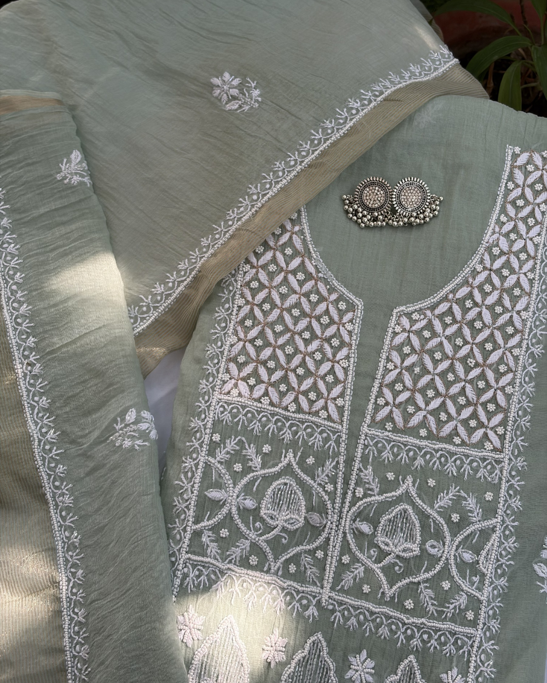 Intricate Lucknowi chikankari art of awadh displayed on a pastel green mul chanderi garment.