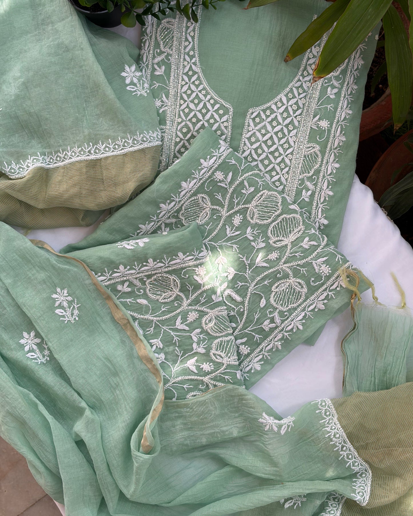 Elegant pistachio green mul chanderi ensemble showcasing Lucknowi chikankari art of awadh for celebrations.