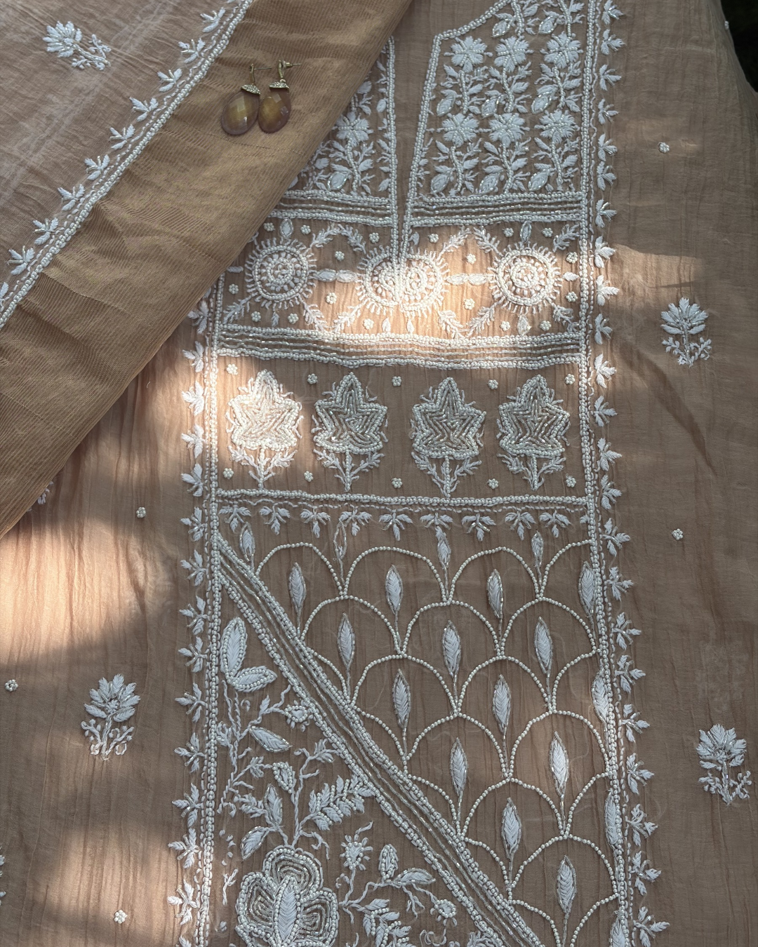 Traditional Lucknowi chikankari art of awadh on rose blush mul chanderi fabric for daytime events.