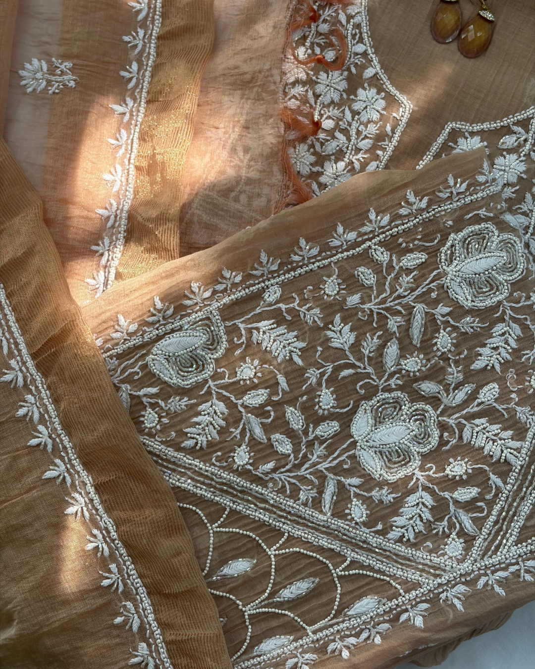 Intricate Lucknowi chikankari art of awadh displayed on a rose blush mul chanderi garment.