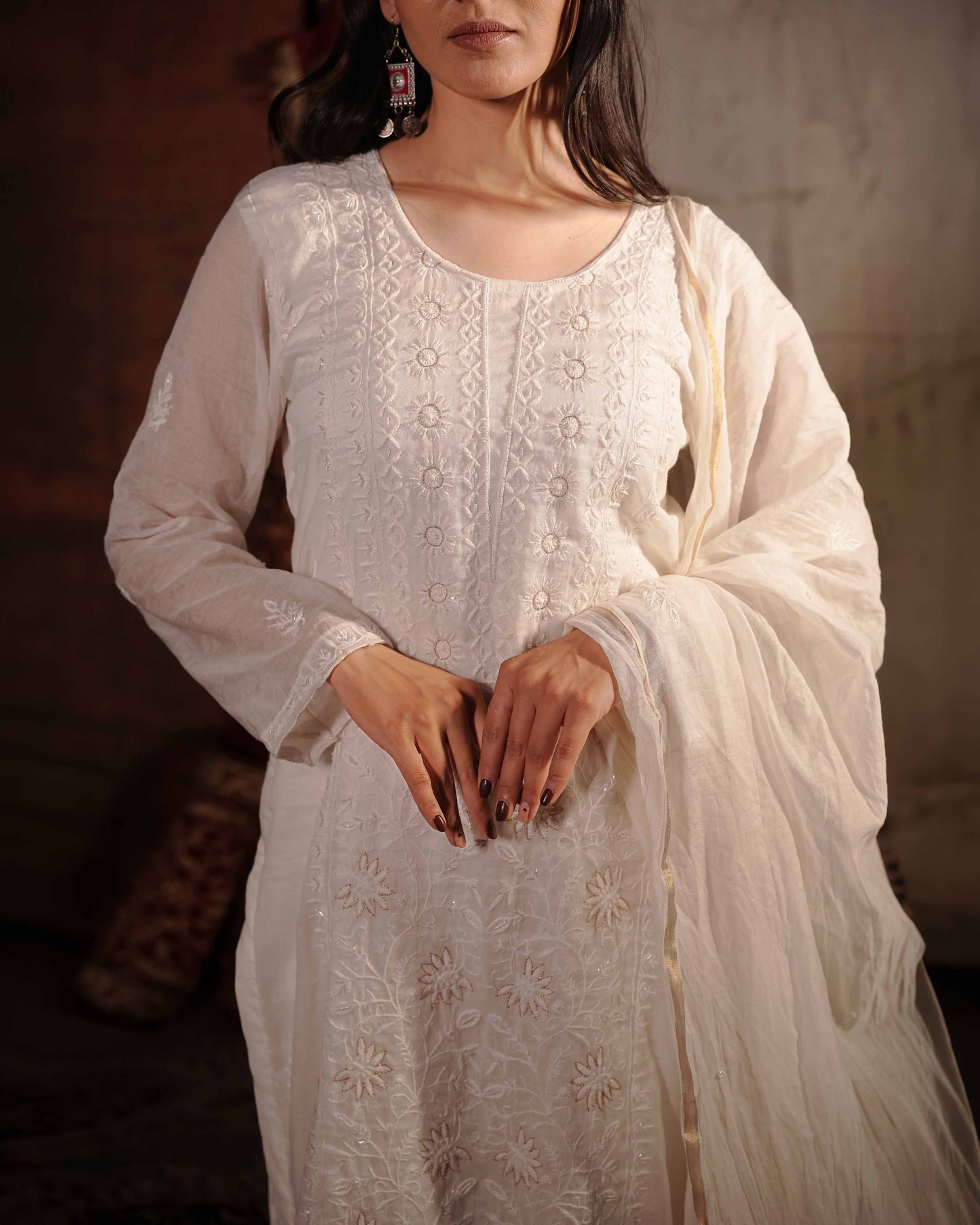 Timeless white Mul Chanderi suit showcasing authentic Art of Awadh chikankari craft.
A premium, elegant choice designed to make a statement at any traditional event.

