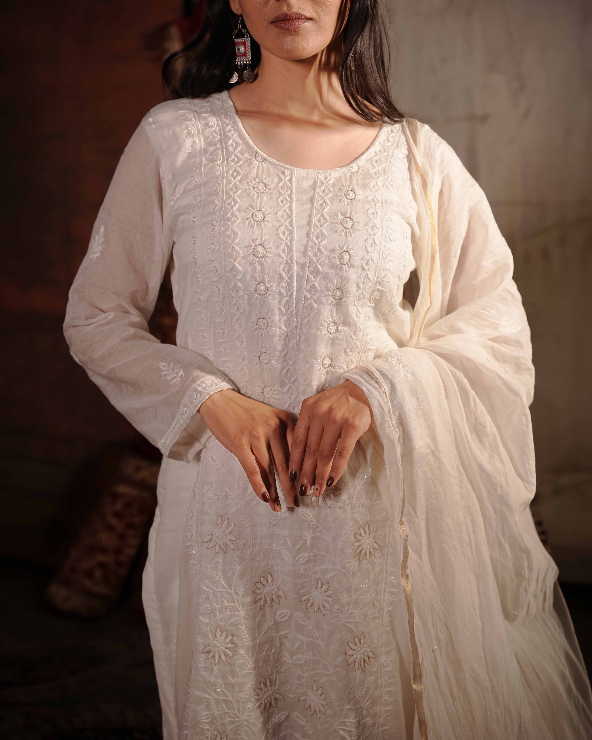 Timeless white Mul Chanderi suit showcasing authentic Art of Awadh chikankari craft.
A premium, elegant choice designed to make a statement at any traditional event.
