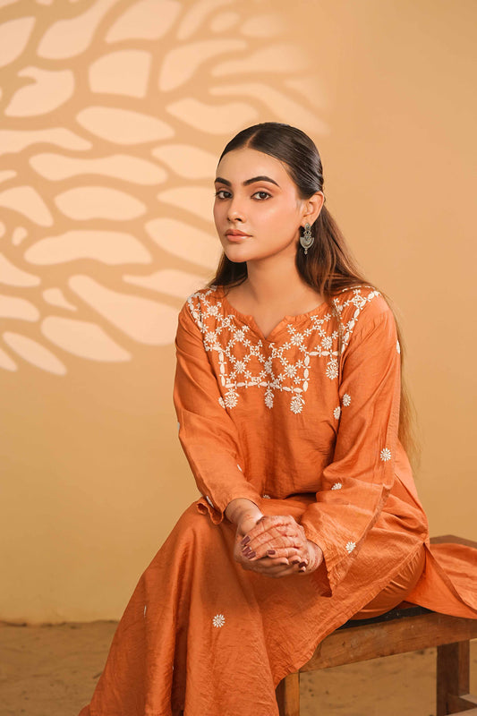 Minimalist rust-colored linen chanderi set highlighting heritage Lucknowi chikankari patterns.
Authentic Art of Awadh apparel designed for refined and sophisticated modern daily wear.
