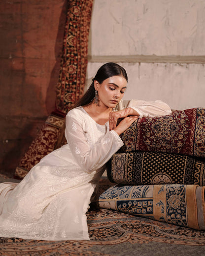 Authentic white chikankari suit in premium Mul Chanderi by Art of Awadh.
Beautifully crafted to ensure you shine at every evening party and traditional event.
