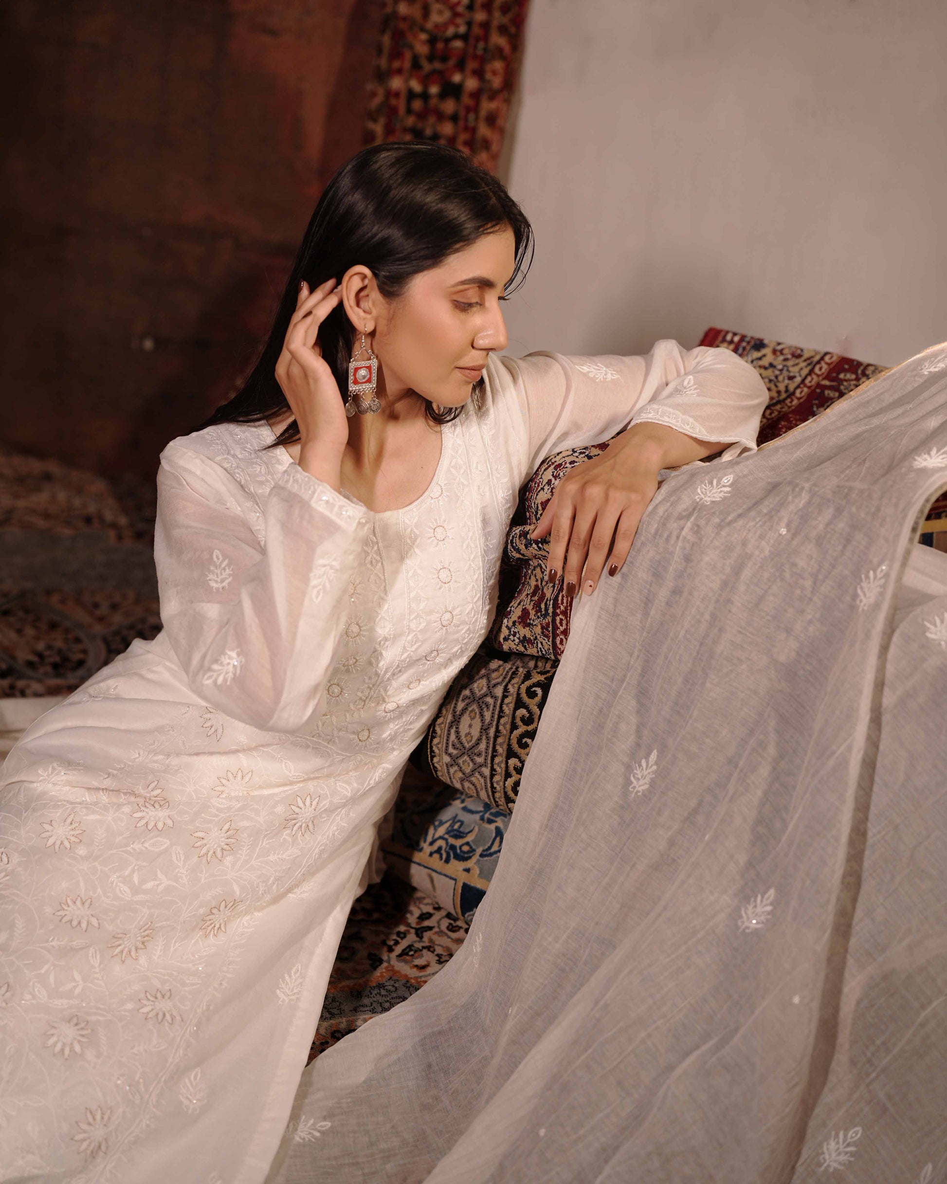 Authentic white chikankari suit in premium Mul Chanderi by Art of Awadh.
Beautifully crafted to ensure you shine at every evening party and traditional event.
