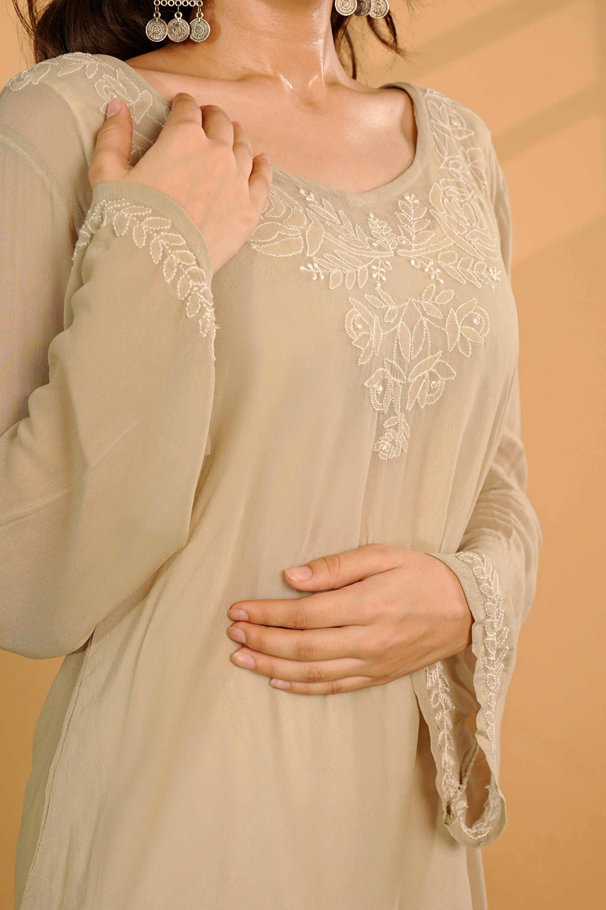 Minimalist viscose georgette kurti featuring subtle Lucknowi chikankari detailing.
Authentic Art of Awadh apparel designed for a refined and sophisticated casual style.
