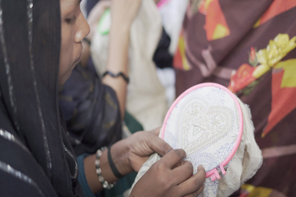Expert hands expertly weaving traditional floral chikankari motifs at the Art of Awadh workshop.