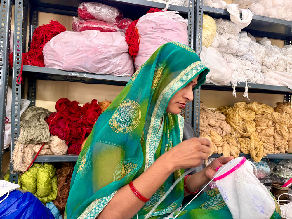 A skilled artisan meticulously performing fine Lucknowi chikankari needlework by hand at Art of Awadh.