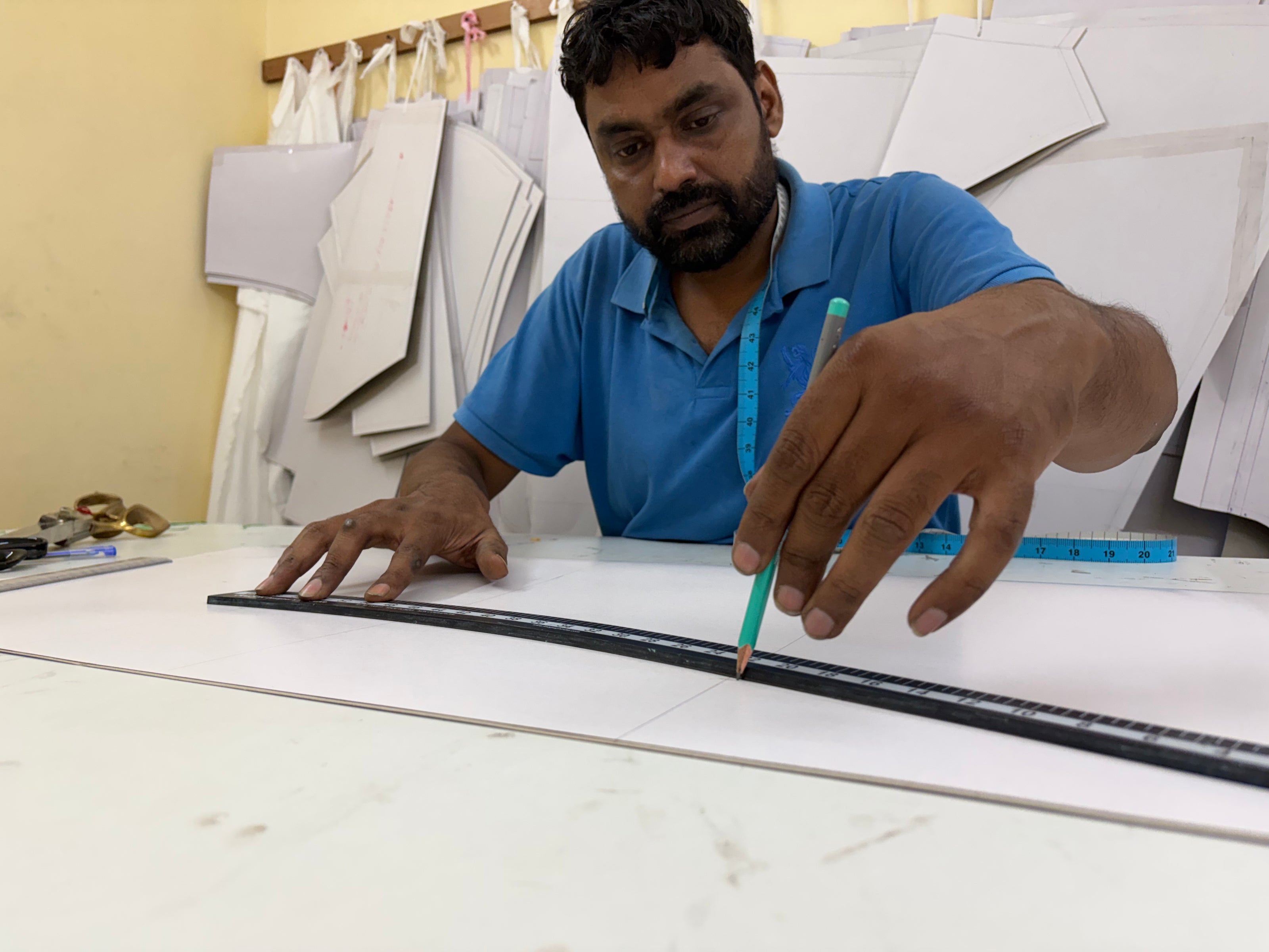 An image highlighting the technical expertise of our tailor and pattern maker, who shapes traditional fabrics into contemporary silhouettes.
Our tailors and pattern makers bring architectural precision to our collection, ensuring that heritage materials are transformed with expert care and modern elegance.